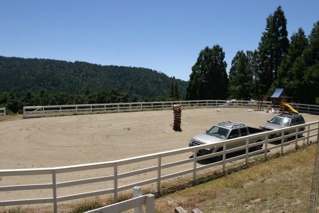 Horse arena and parked cars